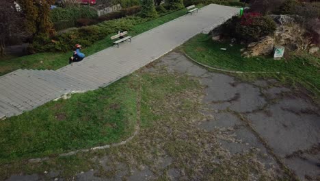 Overhead-Aerial-Drone-Shot-Following-a-Young-Adult-Male-Parkour-Free-Running-Through-The-Park