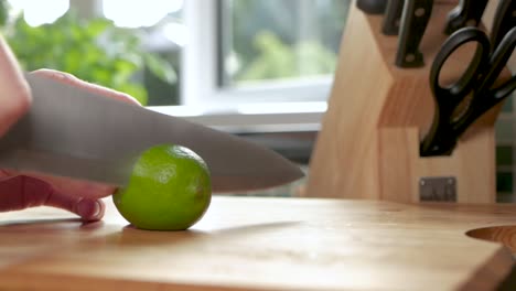Slow-motion-shot-of-a-lime-being-cut-in-half