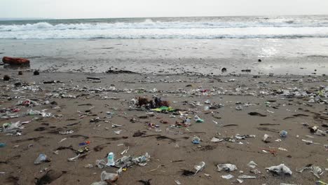 Sandy-beach-full-with-plastic-garbage,-polluted-nature-in-Bali,-Indonesia