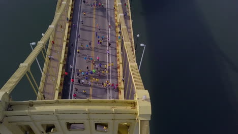 Aerial-passing-over-runners-crossing-bridge,-Pittsburgh-Marathon