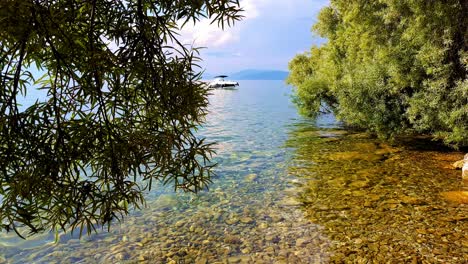 Truck-shot-revealing-boat-on-blue-water-of-Ohrid-Lake-in-Macedonia