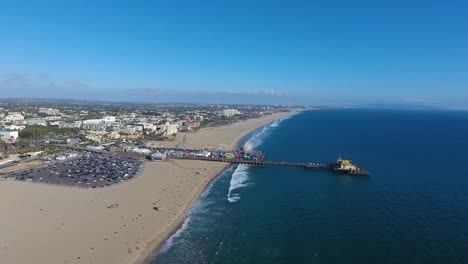Flying-over-Santa-Monica-beach-and-towards-Santa-Monica-Pier-on-summers-day