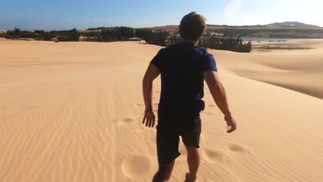 man-running-on-sand-dunes-in-the-desert-of-vietnam