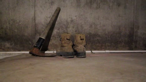 Pickaxe-and-boots-in-a-dark-creepy-basement-with-a-swinging-light