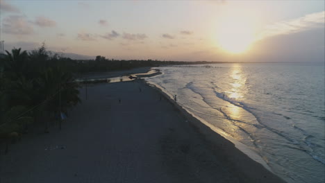 AERIAL:-Slow-motion-sunset-on-Honduran-beach---Tela,-Honduras-3