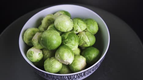 Fresh-and-Wet-Brussel-Sprouts-rotating-on-Black-Background,-4k