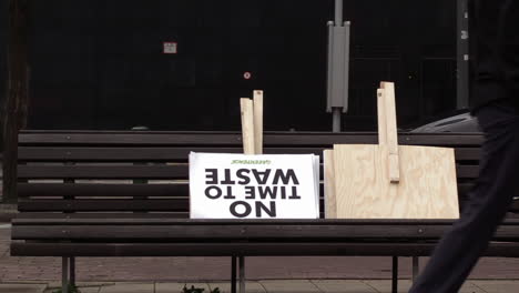 a-protest-sign-from-Greenpeace-laying-outside-on-a-bench-for-the-global-warming-march-event