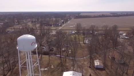 Left-to-right-pan-across-the-face-of-a-water-tower-in-rural-Southern-Illinois-overlooking-farmland
