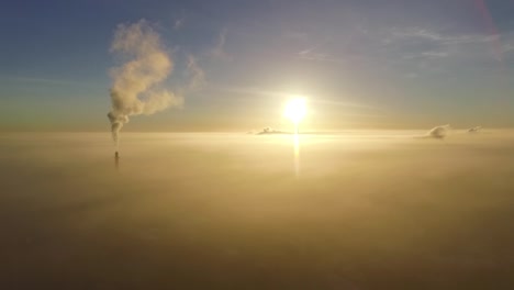 Dense-fog-over-city-Valmiera-in-early-winter-morning-sunlight-aerial-footage-wide-shot