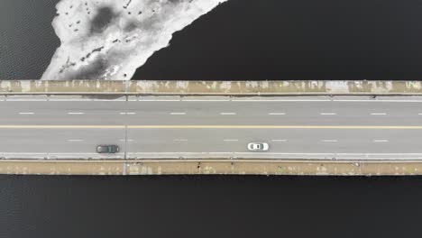 Cars-on-Bridge-Travelling-Cross-Frozen-Charles-River,-Boston,-Massachusetts