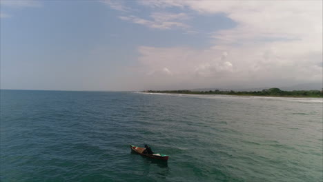 AERIAL:-Slow-motion-Honduran-fisherman-fishing-from-canoe-near-caribbean-coast---El-Porvenir,-Honduras-2
