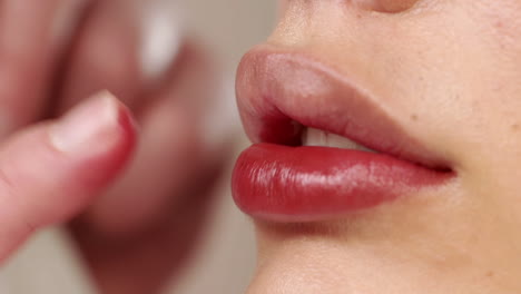 applying-red-lipstick-on-beautiful-lips