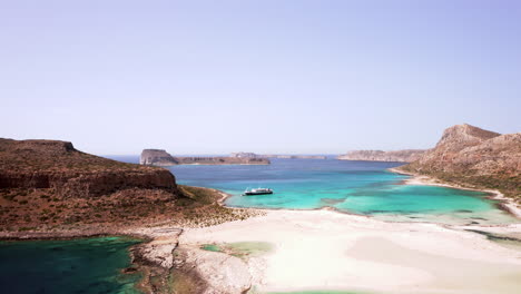 Aerial-Dolly-Shot-of-Balos-Beach-in-Northern-Crete,-Greece-moving-Away-from-the-Lagoon-on-a-Beautiful-Sunny-Day