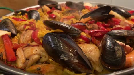 traditional-spanish-paella-just-finished-cooking-close-up-macro-with-steam-rising-from-the-hot-rice-dish,-filmed:-marbella-malaga-spain