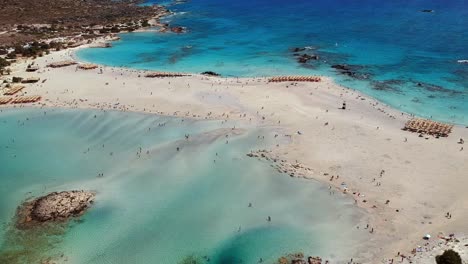 Aerial-shot-of-this-blue-and-turquoise-waters-of-the-white-sand-beach-Elafonissi-in-Crete,-Greece