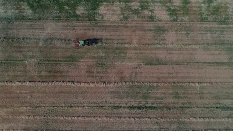 An-overhead-shot-of-a-tractor-plowing-the-ground