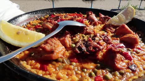 Beautiful-traditional-Paella-at-the-beach,-sunny-weather-in-Marbella,-Spain