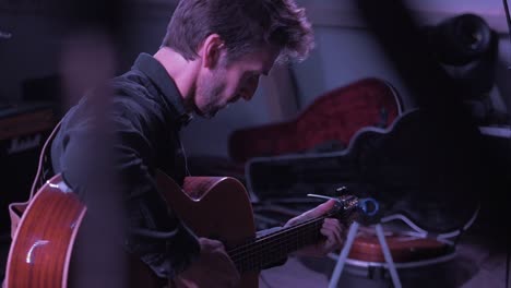 Musician-tuning-guitar-on-stage-before-festival