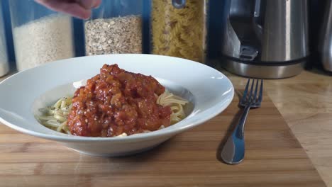 Slow-Motion-Shot-of-Pepper-Being-Sprinkled-on-Pasta-and-Tomate-Sauce