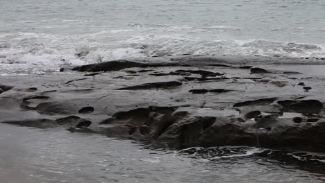 Ocean-waves-crashing-brutally-over-seaside-rocks