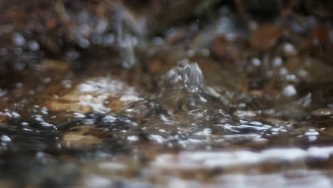 Water-running-into-a-drainage-ditch,slow-motion-and-close-up