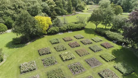 Drone-Slowmotion-of-an-Dutch-Flower-Garden-during-Spring,-with-lots-of-Flowers-and-Green-Trees