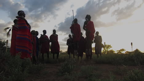 A-Maasai-tribe-engage-in-ritual-dances-at-sunset-on-tribal-lands-near-Amboseli-National-park-during-late-summer-under-cloudy-skies