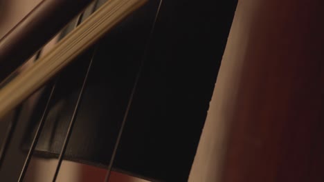 macro-close-up-of-cello,-cello-bow-,-cello-playing-and-strings