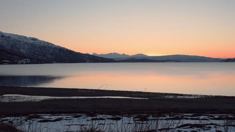 Smooth-evening-view-over-fjord-to-mountains-panorma-with-sunset