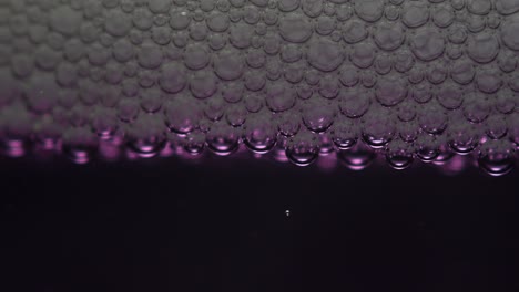 Closeup-of-soap-bubbles-on-purple-liquid