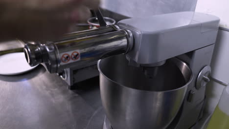 Chef-rolling-out-pasta-with-a-mixer-attachment