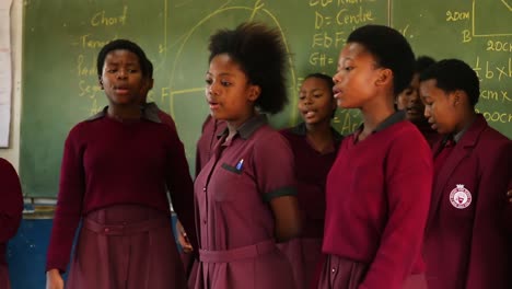Nahaufnahme-Von-Schwarzen-Afrikanischen-Teenager-Mädchen,-Die-Im-Klassenzimmer-Singen-Und-Tanzen