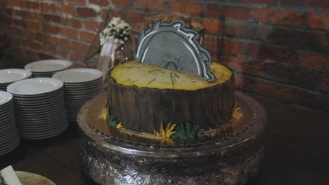 Slow-Motion-Pan-shot-of-Wedding-Cake-designed-as-Wood-and-Saw