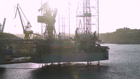 Port-structure-and-ship-cranes-in-the-water-of-Malta's-famous-Three-Cities