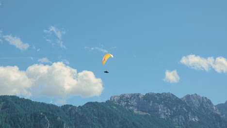 Flying-in-the-mountains,-paraglider-in-Alpine-landscape,-freedom-and-adventure-concept,-adrenaline-sport,-Logar-valley-in-Slovenia