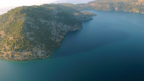 Aerial-drone-flying-over-marmaris-marina,-castle-with-sailing-boats,-yachts-in-the-bay-lagoon