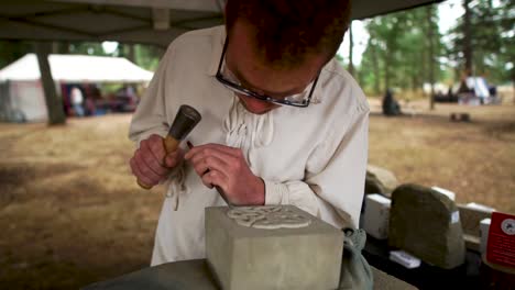 A-stonemason-demonstrates-the-carving-of-sandstone-at-the-festival