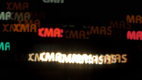 Beautiful-Xmas-text-shaped-bokeh-from-moving-car-and-traffic-lights-at-the-evening,-Christmas,-winter-or-holiday-background-concept,-copyspace