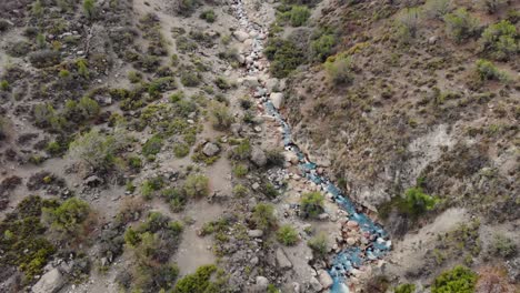Aerial-drone-shot-following-river-in-valley-at-Cordillera-de-los-Andes