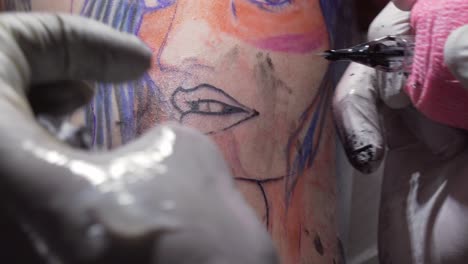 Tattoo-artist-applying-vaseline-gel-after-tattooing,-professional-work,-close-up-view