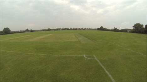 A-fast-view-along-an-empty-sports-field-in-England,-United-Kingdom