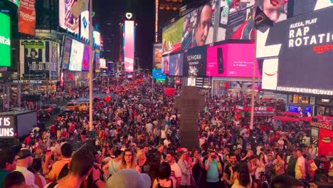 Times-Square-is-a-busy-tourist-intersection-of-neon-art-and-commerce-and-is-an-iconic-street-of-New-York-City-downtown-in-Manhattan,-America
