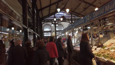 Slow-Motion-walking-past-people-at-fresh-fish-stands-in-Spanish-market