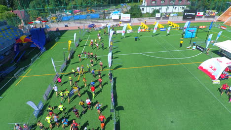 Aerial-Shot-of-the-Running-Start-line-of-an-Obstacle-Race