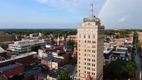 Aerial-turn-revealing-Griest-Building,-Lancaster,-Pennsylvania,-in-summer-with-rainbow,-aerial-view