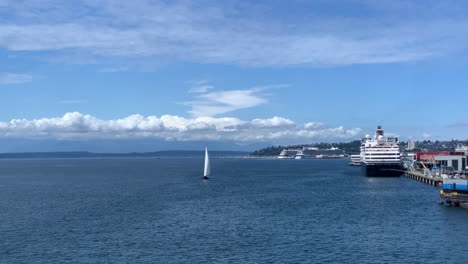 a-sailboat-in-Elliot-Bay-in-Seattle-Washington-sails-towards-camera