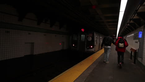 Train-speeds-up-leaving-a-station-in-the-underground-metro-system-of-New-York-City