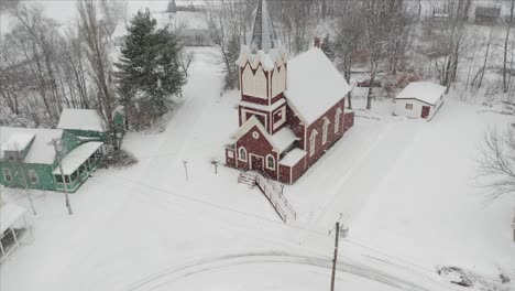 Beautiful-church-amidst-snowfall-Aerial-4K