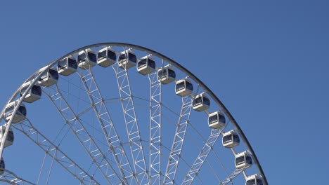 A-big-white-wheel-behind-a-blue-sky
