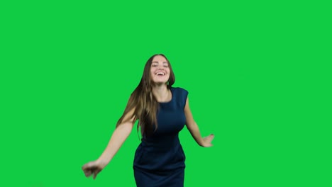 Happy-girl-dancing-in-front-of-the-green-screen